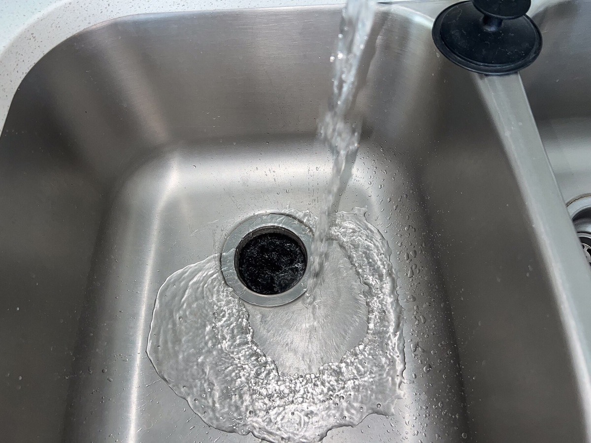 Water running into a stainless steel kitchen sink
